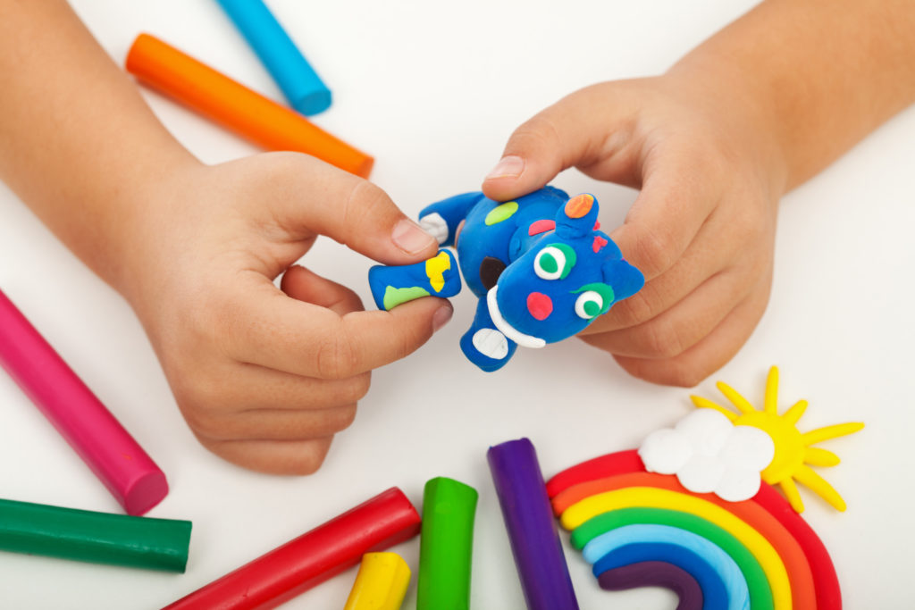 Child playing with colorful clay