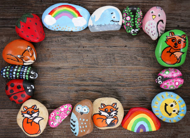 rock painting ideas different painted rocks on wooden background