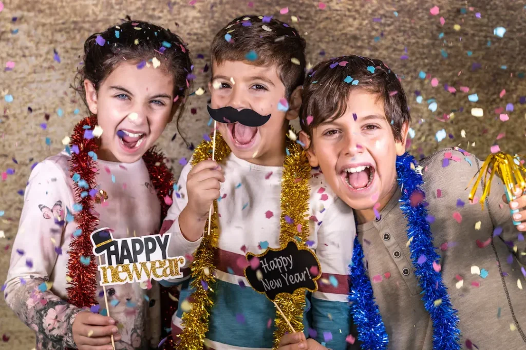 Three cheerful children celebrating with 