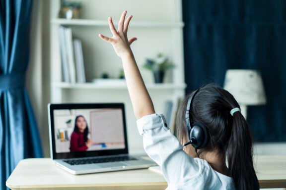 Homeschool Asian little young girl student learning virtual inte